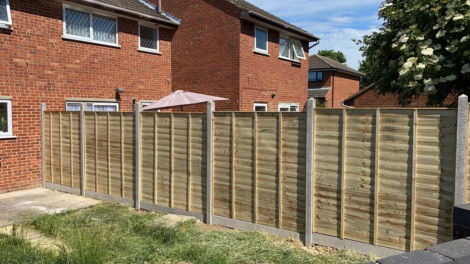 New close-board fencing run with concrete posts and gravel boards along a rear garden boundary